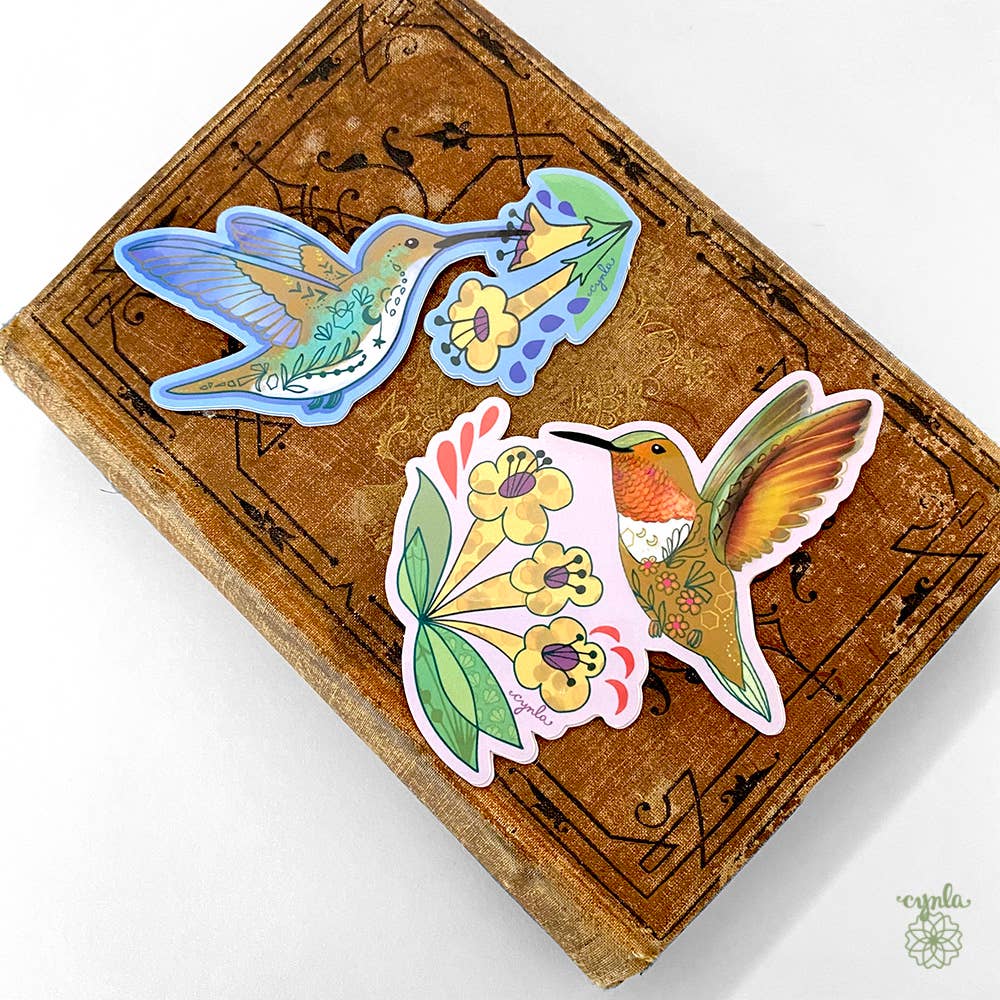 Cynla - Hummingbird Dance Birthday Card - orange bird flower garden
